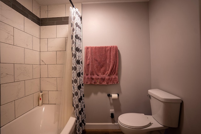 bathroom featuring toilet and shower / tub combo with curtain