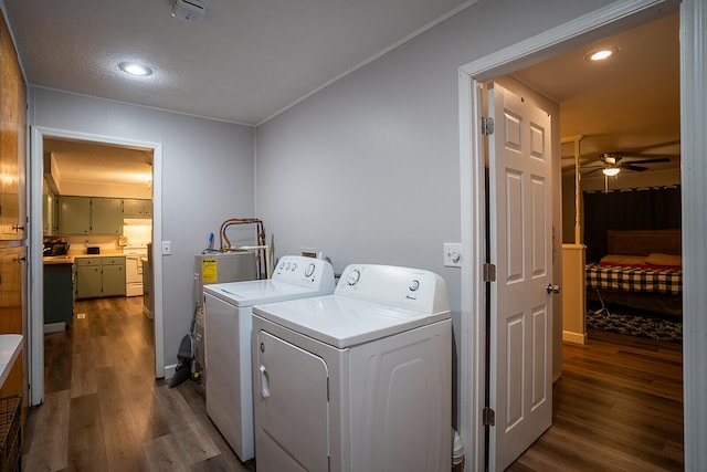 clothes washing area with washer and clothes dryer, ceiling fan, dark wood-type flooring, ornamental molding, and a textured ceiling