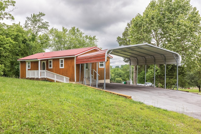 exterior space featuring a carport, a front lawn, and covered porch