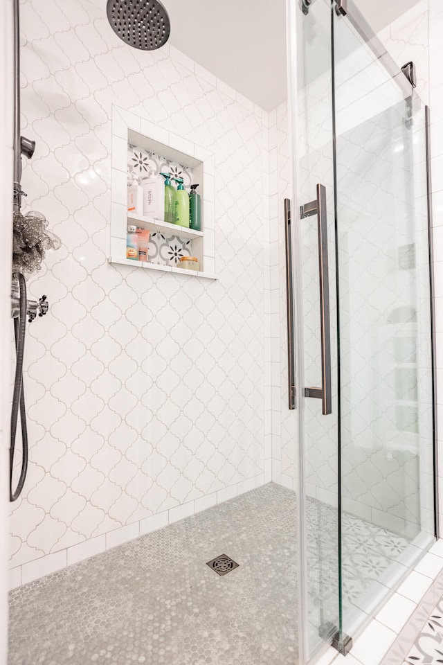 bathroom featuring a shower with door