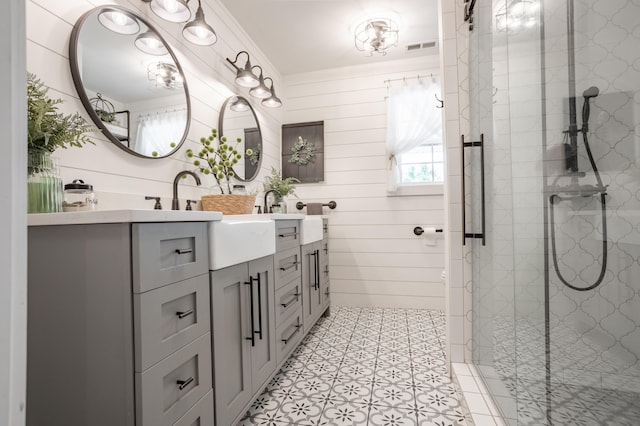 bathroom featuring walk in shower, vanity, and wooden walls