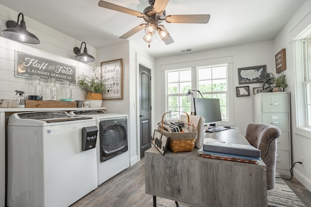 laundry room with ceiling fan, washer and clothes dryer, and wood-type flooring