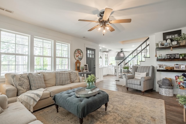 living room featuring hardwood / wood-style flooring, a healthy amount of sunlight, and ceiling fan