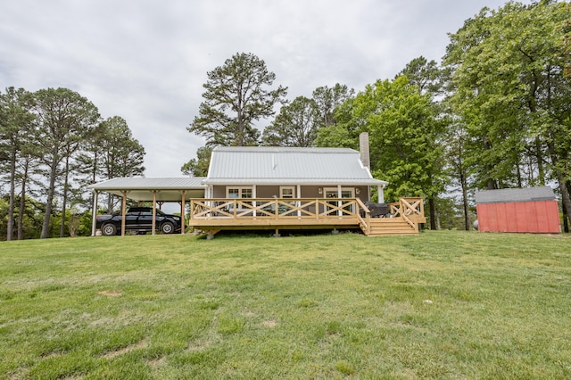 back of house featuring a wooden deck, a yard, and a storage unit