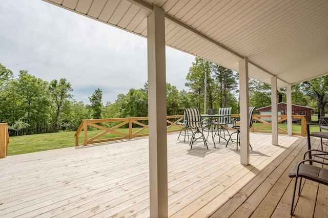 wooden deck with a lawn