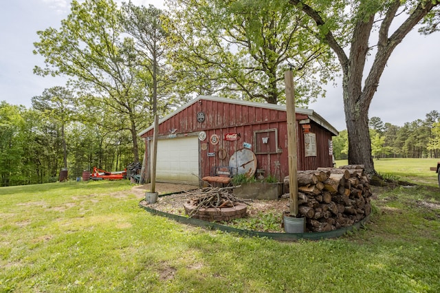 view of outdoor structure featuring a lawn and a garage