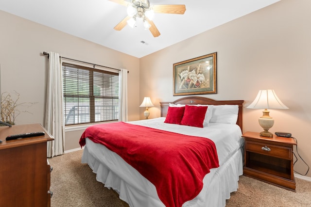 carpeted bedroom with visible vents, baseboards, and ceiling fan