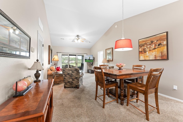 dining area with vaulted ceiling, visible vents, light colored carpet, and ceiling fan