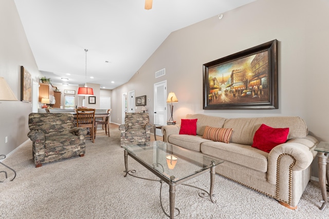 carpeted living area featuring vaulted ceiling, a ceiling fan, and visible vents