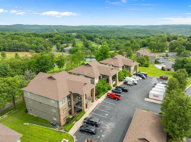 drone / aerial view with a wooded view