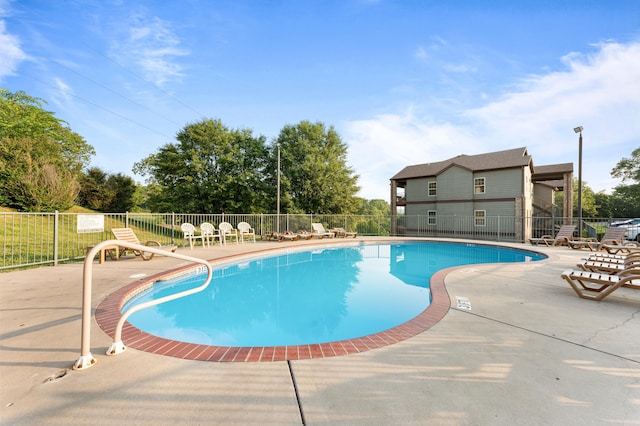 pool featuring a patio area and fence