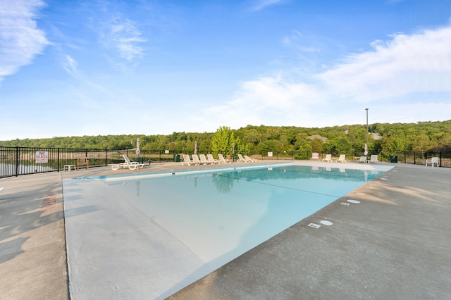 pool with fence and a patio area