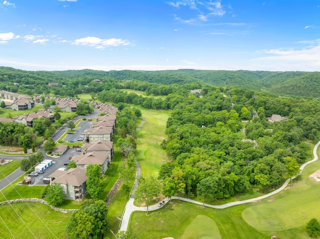 birds eye view of property featuring a forest view, view of golf course, and a residential view
