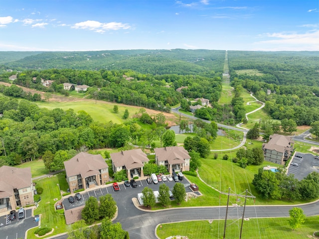 birds eye view of property with a view of trees