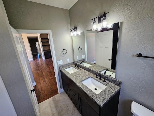 bathroom featuring wood-type flooring, vanity, and toilet