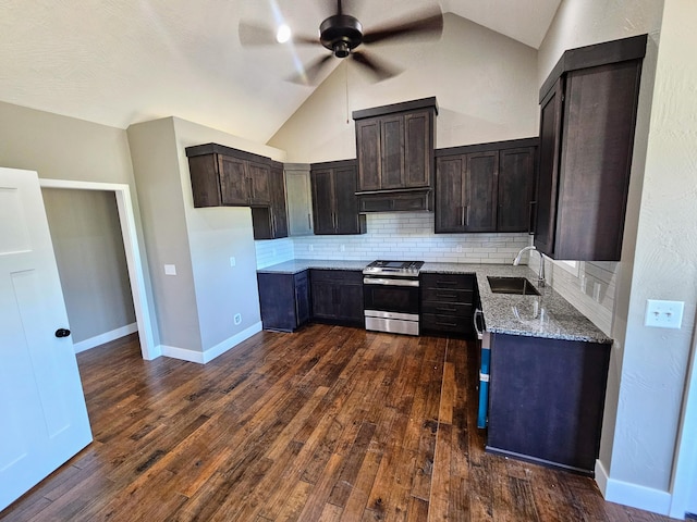 kitchen featuring sink, stainless steel range oven, light stone countertops, dark hardwood / wood-style flooring, and decorative backsplash