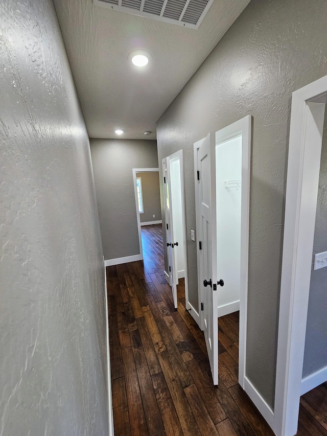 corridor featuring dark wood-type flooring