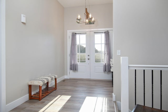 entryway featuring a notable chandelier, hardwood / wood-style floors, and french doors