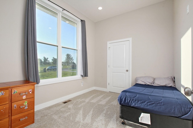 bedroom featuring light colored carpet, baseboards, and visible vents