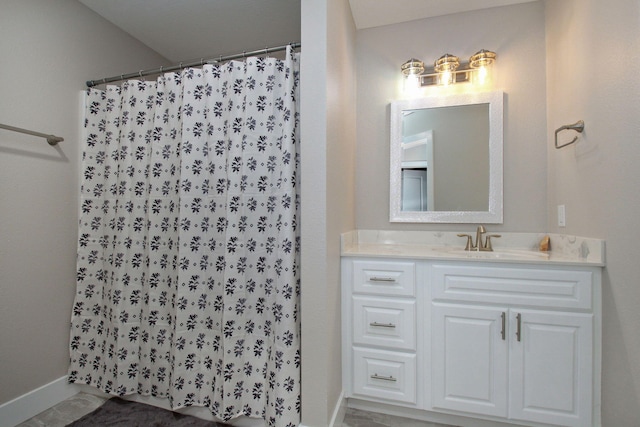 bathroom with curtained shower and vanity