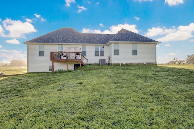 back of property featuring a shingled roof, a wooden deck, a lawn, and cooling unit