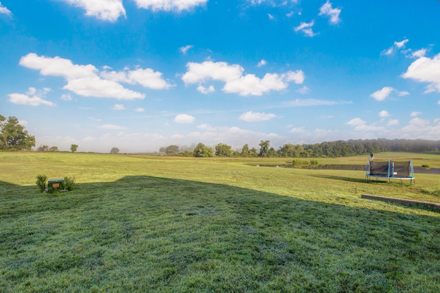view of yard with a rural view and a trampoline