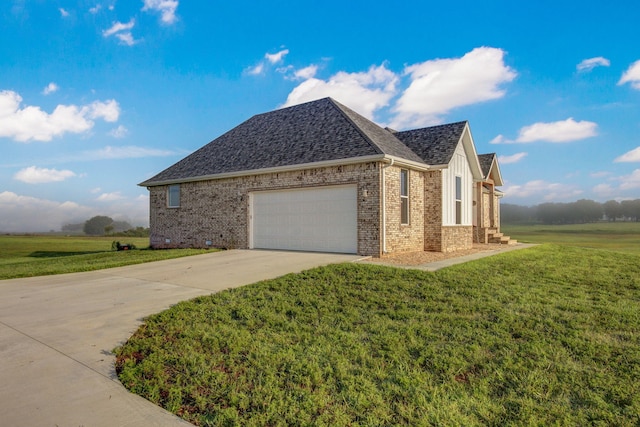 view of side of home with a yard and a garage