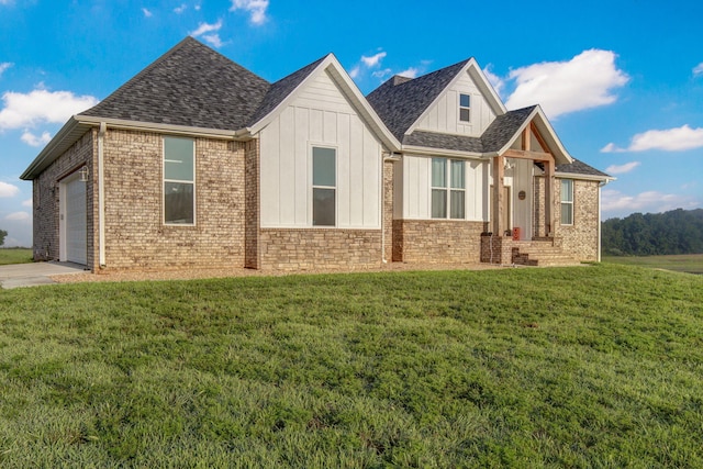view of front of property with a garage, board and batten siding, and a front yard