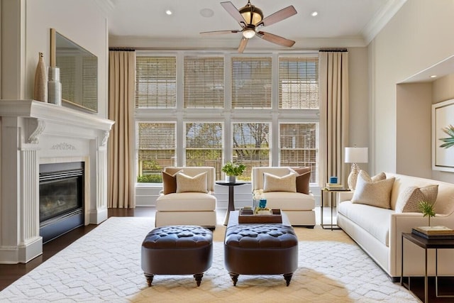 living room featuring ornamental molding, hardwood / wood-style flooring, and ceiling fan