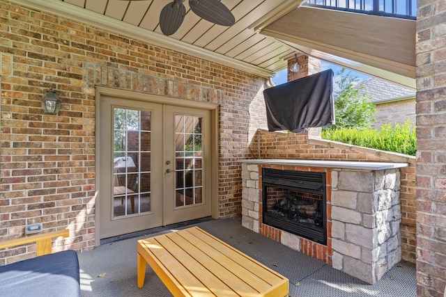 view of patio / terrace with french doors, exterior fireplace, and ceiling fan