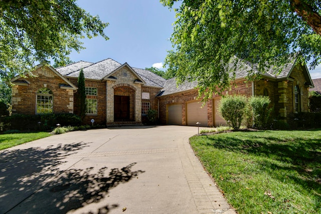 view of front of house with a front yard and a garage