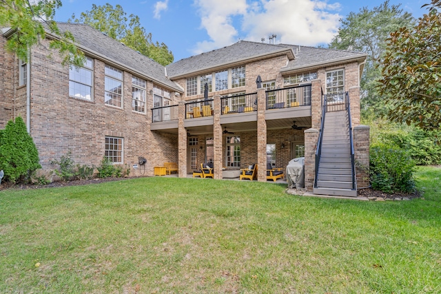 rear view of property with a patio, a lawn, and a deck