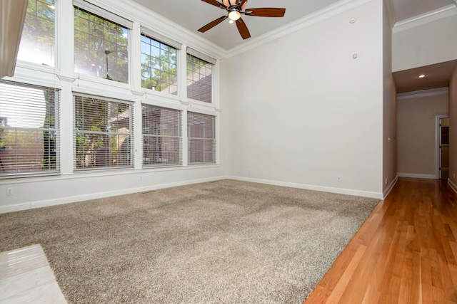 spare room with hardwood / wood-style flooring, crown molding, and ceiling fan