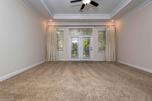 unfurnished room featuring carpet floors, a raised ceiling, and ornamental molding