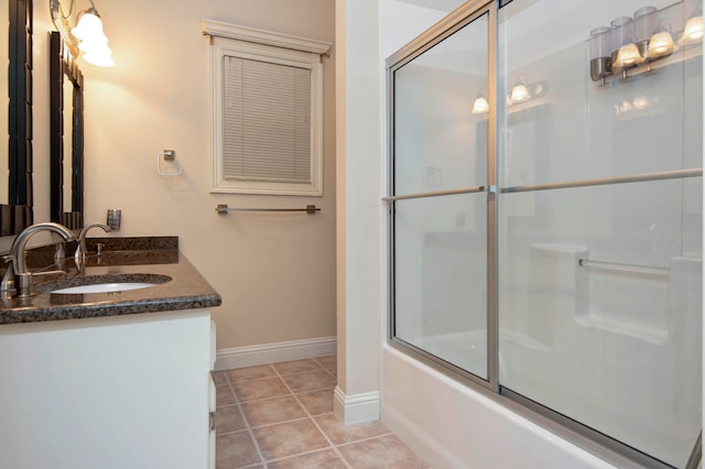 bathroom featuring bath / shower combo with glass door, tile patterned flooring, and vanity