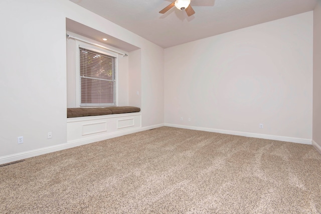 carpeted empty room featuring ceiling fan