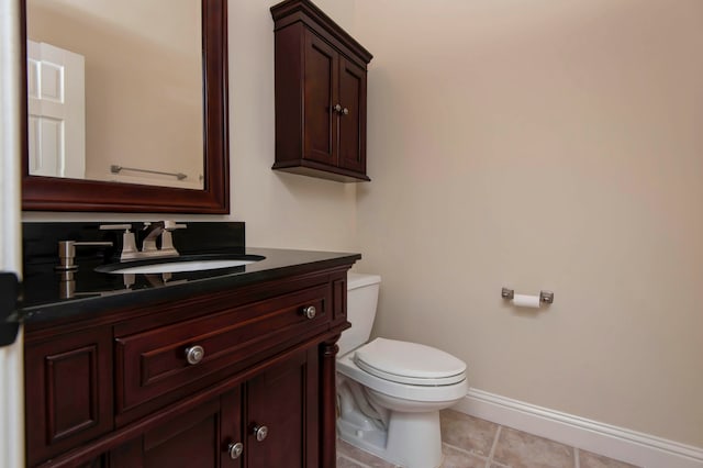 bathroom with tile patterned floors, vanity, and toilet