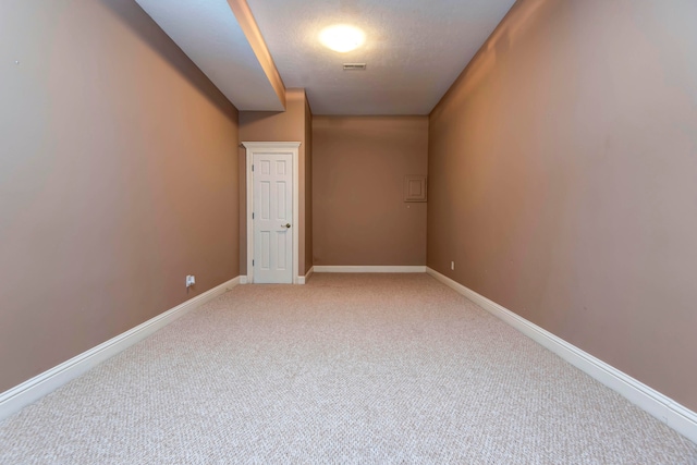 carpeted spare room with a textured ceiling