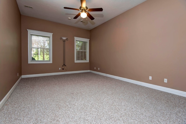 carpeted empty room featuring ceiling fan