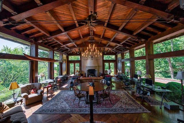 living room featuring ceiling fan with notable chandelier, wood ceiling, beam ceiling, and high vaulted ceiling