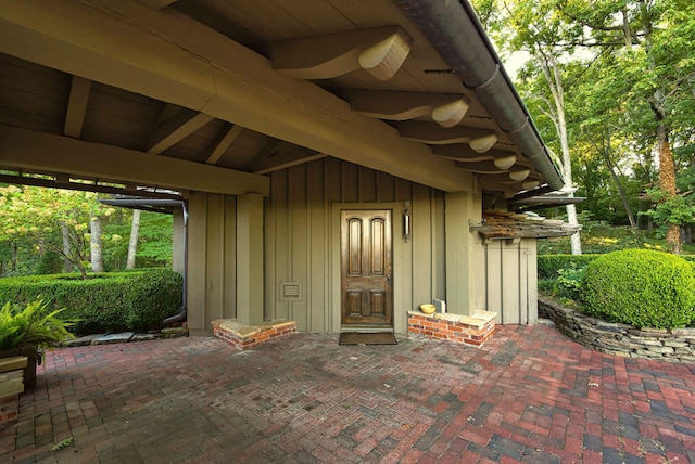 view of exterior entry featuring a patio