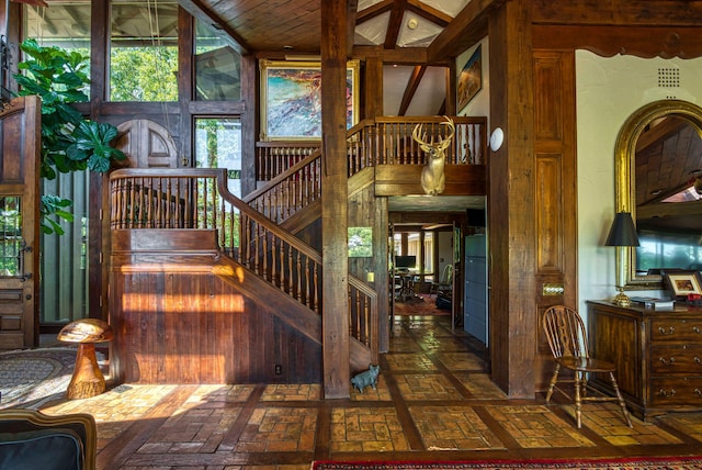 staircase featuring lofted ceiling and wooden ceiling