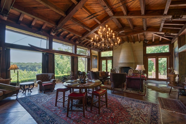 dining area with a healthy amount of sunlight, a fireplace, and beamed ceiling