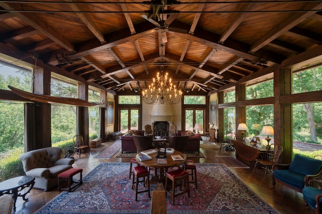 sunroom with lofted ceiling with beams, a notable chandelier, and wood ceiling