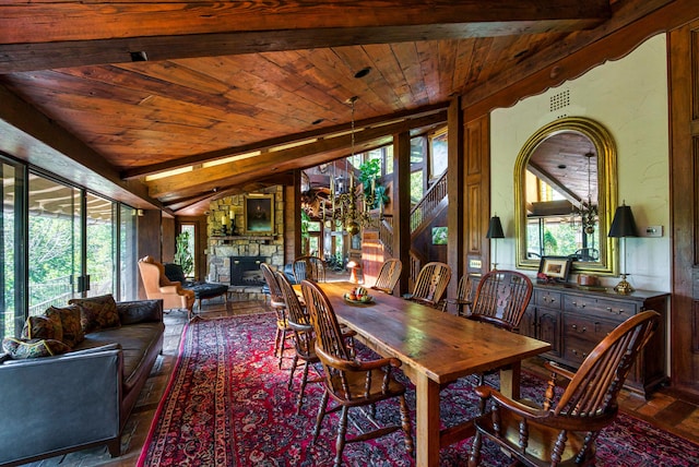 dining room featuring wood-type flooring, a fireplace, lofted ceiling with beams, and wood ceiling