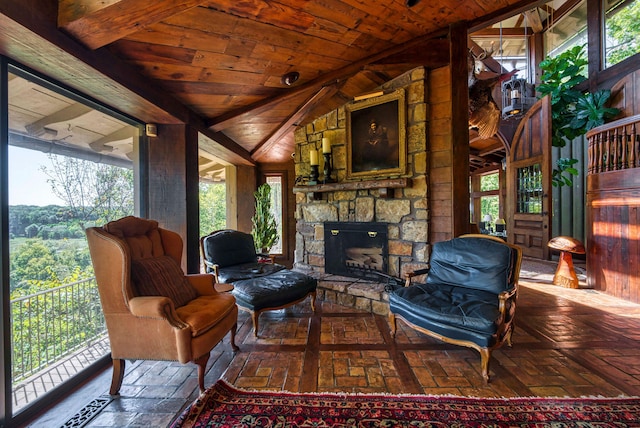 living room with a stone fireplace, wood ceiling, and lofted ceiling with beams