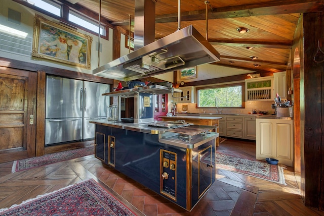 kitchen featuring stainless steel counters, appliances with stainless steel finishes, dark parquet floors, and a center island