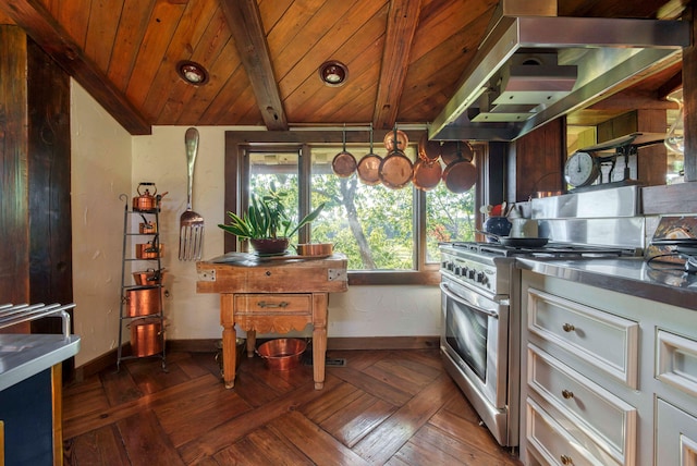 kitchen featuring dark parquet floors, high end range, island range hood, stainless steel counters, and lofted ceiling with beams