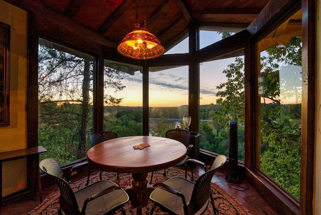 sunroom featuring wood ceiling and vaulted ceiling with beams