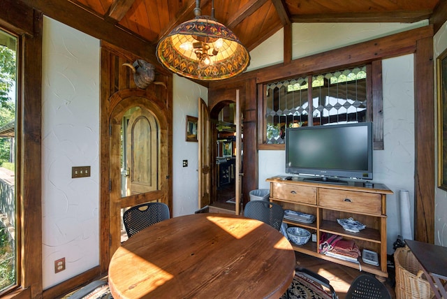 dining area featuring plenty of natural light, wooden ceiling, and vaulted ceiling with beams